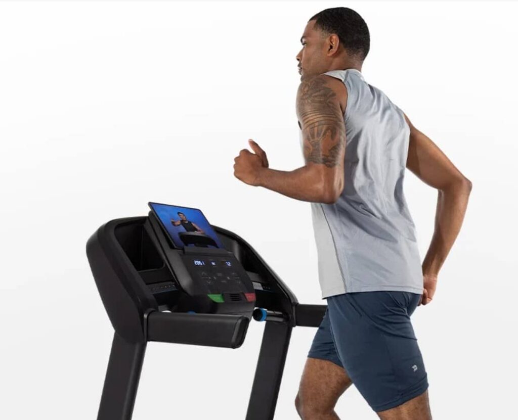 Horizon Fitness T101 Man Looking at Tablet Compressed