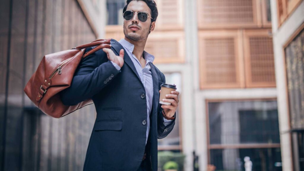 Man holding bag and coffee