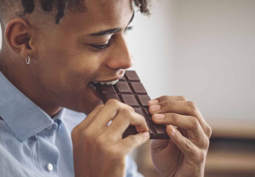 Person eating chocolate bar